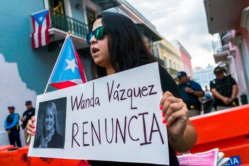(AP Photo/Dennis M. Rivera Pichardo). Protesters gather outside the government mansion La Fortaleza in San Juan, Puerto Rico, Wednesday, Aug. 7, 2019, calling for the removal of the island's newly sworn-in governor, ex-Justice Secretary Wanda Vazque