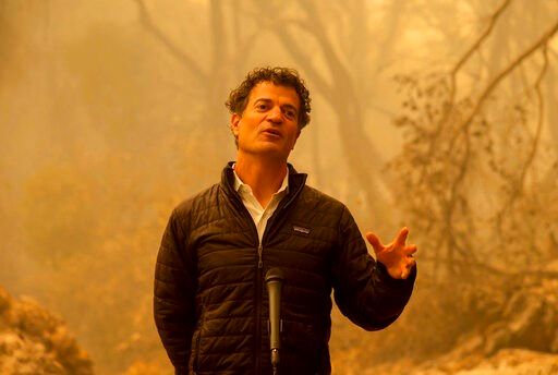 Amid ashes, California governor fires away on climate change