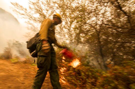 Crews battling California fires head to devastated areas