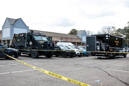Armed man rammed vehicle into Michigan synagogue and was fatally shot by security, AP source says